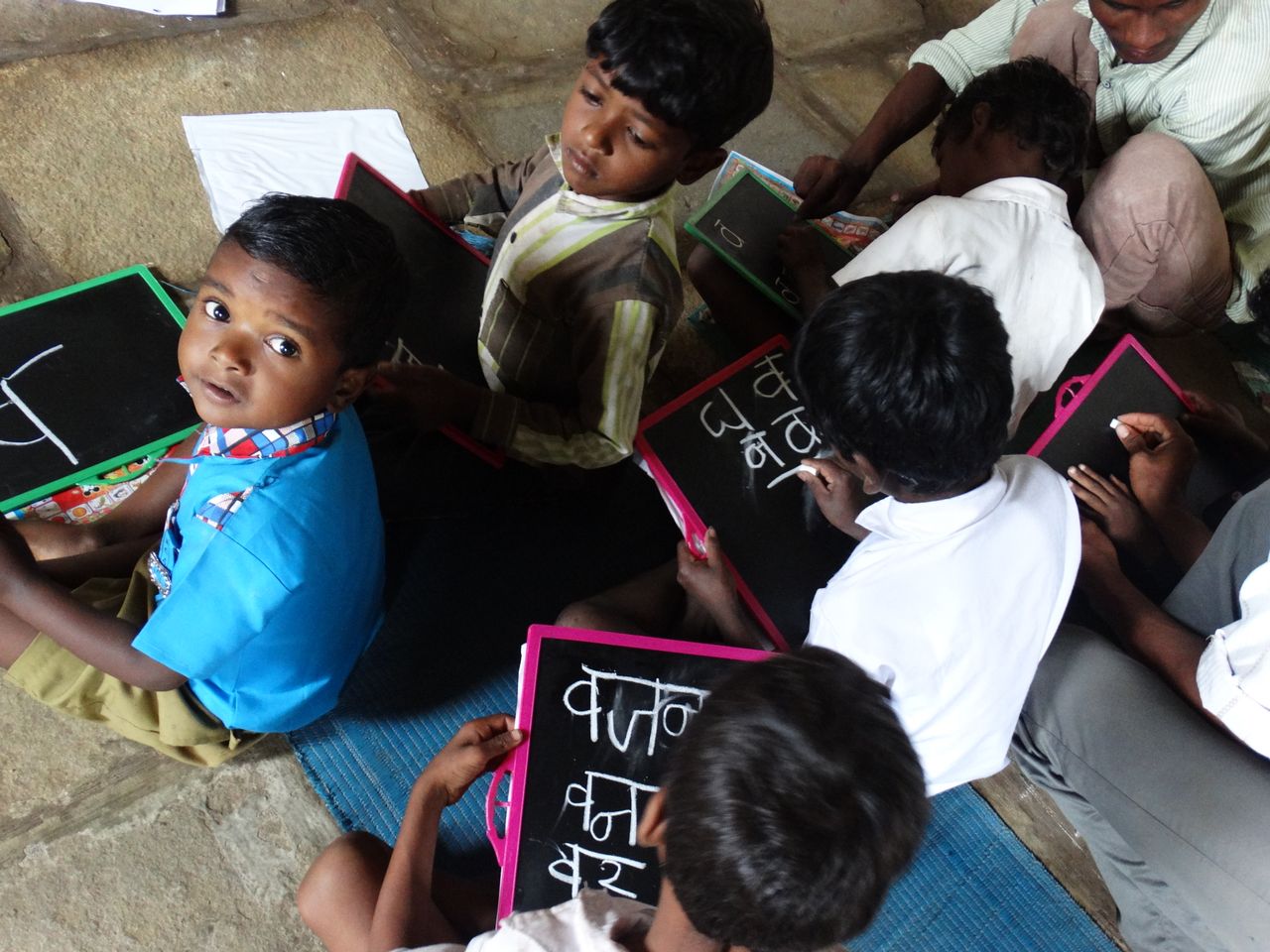 The Art of Drawing Readers In: Your attractive post title goes here Young students writing on slates in a village school in Melghat, India.