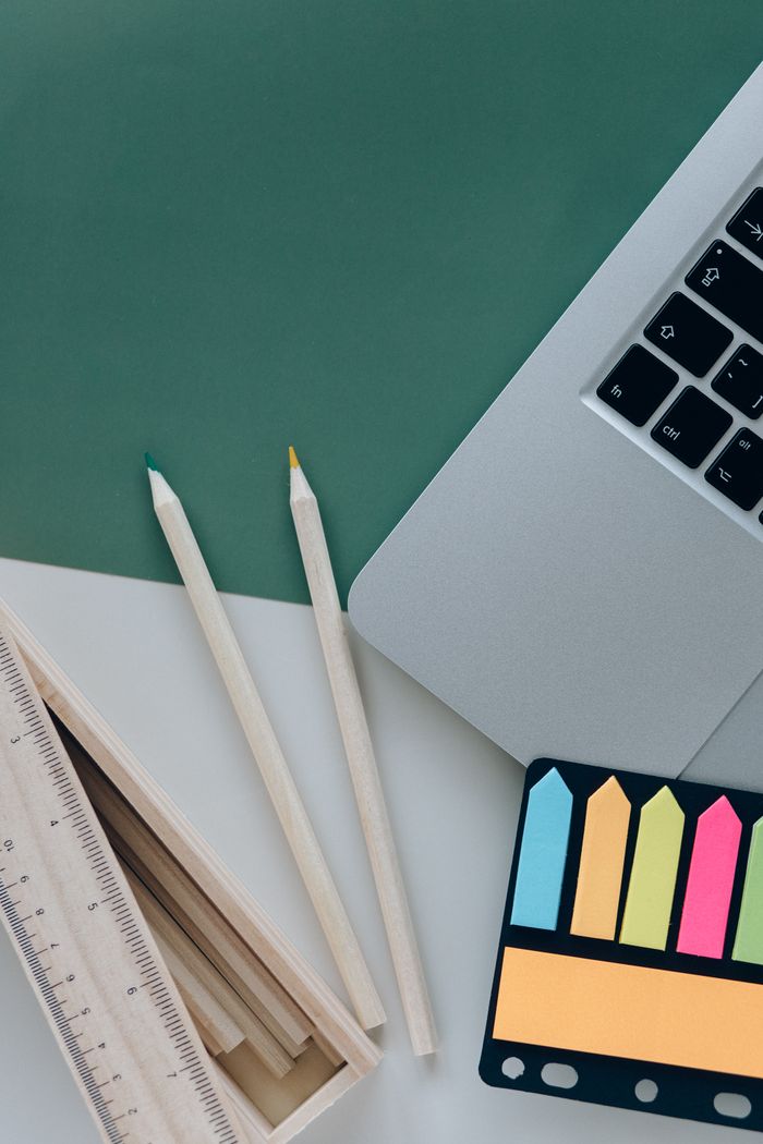 Mastering the First Impression: Your intriguing post title goes here Flat lay of colorful pencils, laptop, ruler, and sticky notes on a desk.